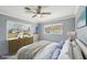 Bedroom featuring plush carpet, a ceiling fan, and a comfortable bed. (Virtually Staged) at 1537 Overbrook Rd, Englewood, FL 34223