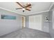 Bright bedroom features new carpet, a ceiling fan, closet, and a fresh coat of paint at 1537 Overbrook Rd, Englewood, FL 34223