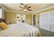 Warm primary bedroom with carpet, ceiling fan, and access to adjoining living space at 1537 Overbrook Rd, Englewood, FL 34223