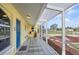 Screened in porch, perfect for relaxing with cool tile and front yard views at 1537 Overbrook Rd, Englewood, FL 34223