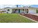 Charming single-story home with well-maintained lawn, colorful landscaping, and screened in porch at 1537 Overbrook Rd, Englewood, FL 34223