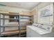 Practical laundry room with washer, dryer, and plenty of shelving for storage solutions at 1537 Overbrook Rd, Englewood, FL 34223