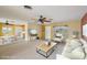 Staged living room showcasing a comfortable seating arrangement and views of the dining area and kitchen at 1537 Overbrook Rd, Englewood, FL 34223
