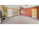 Unfurnished living room with neutral-toned walls, new carpet, and a large window at 1537 Overbrook Rd, Englewood, FL 34223