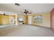 Bright living room featuring a large window, access to the kitchen, and neutral-colored walls at 1537 Overbrook Rd, Englewood, FL 34223