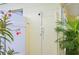 Convenient outdoor shower with a white fence and surrounded by lush tropical plants at 1537 Overbrook Rd, Englewood, FL 34223