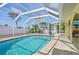 Sparkling pool surrounded by brick pavers and a screened enclosure for all-season enjoyment at 1537 Overbrook Rd, Englewood, FL 34223