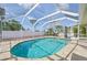 Inviting screened pool with outdoor seating, set in a private backyard oasis at 1537 Overbrook Rd, Englewood, FL 34223