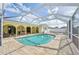 Inviting screened-in pool area with beautiful brick pavers and ample space for outdoor enjoyment at 1537 Overbrook Rd, Englewood, FL 34223