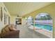 Covered pool area featuring comfortable seating and views of the pool at 1537 Overbrook Rd, Englewood, FL 34223