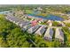 Aerial view of a neighborhood showcases houses with lakes and a golf course in a well-maintained community at 1625 Lancashire Dr, Venice, FL 34293