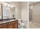Well-lit bathroom with a dark countertop and a large mirror, providing both functionality and a touch of sophistication at 1625 Lancashire Dr, Venice, FL 34293