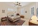 Cozy bedroom featuring a brass bed frame, ceiling fan, and neutral color palette at 1625 Lancashire Dr, Venice, FL 34293