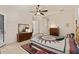 Well-lit bedroom featuring tile floors, ceiling fan, and traditional furnishings at 1625 Lancashire Dr, Venice, FL 34293