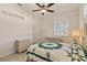 Bedroom featuring a woven bed frame, ceiling fan, and neutral color palette at 1625 Lancashire Dr, Venice, FL 34293