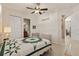Bedroom featuring a woven bed frame, ceiling fan, and access to the bathroom at 1625 Lancashire Dr, Venice, FL 34293