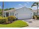 Single-Gathering home with a paver driveway, a two-car garage, and lush landscaping at 1625 Lancashire Dr, Venice, FL 34293
