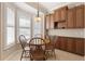 Breakfast nook with bright natural light, wooden table, and wooden cabinets at 1625 Lancashire Dr, Venice, FL 34293