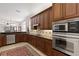 Gourmet kitchen with stainless steel appliances, granite countertops, and wood cabinets at 1625 Lancashire Dr, Venice, FL 34293