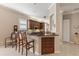 A spacious kitchen with wood cabinets, granite countertops, and a breakfast bar with seating at 1625 Lancashire Dr, Venice, FL 34293