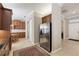 Open kitchen features stainless steel refrigerator and wood cabinets at 1625 Lancashire Dr, Venice, FL 34293