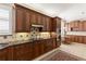 Spacious kitchen with granite countertops, wood cabinets, and stainless steel appliances at 1625 Lancashire Dr, Venice, FL 34293
