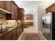 Well-appointed kitchen featuring stainless steel refrigerator and wood cabinets at 1625 Lancashire Dr, Venice, FL 34293