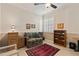 Charming home office featuring tile floors, built in bookcase, and a comfortable loveseat at 1625 Lancashire Dr, Venice, FL 34293