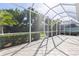 A screened patio providing a tranquil outdoor space with views of lush green landscaping at 1625 Lancashire Dr, Venice, FL 34293