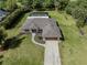 Aerial view showcasing a home, pool, lush backyard, and expansive greenery at 1653 Albino St, Nokomis, FL 34275