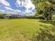 Spacious backyard with lush green grass and a screened-in pool at 1653 Albino St, Nokomis, FL 34275