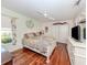 Bright bedroom with wood floors, a ceiling fan, and closet space at 1653 Albino St, Nokomis, FL 34275