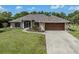 Inviting single-story home with a well-manicured lawn and a two-car garage at 1653 Albino St, Nokomis, FL 34275