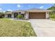 Well-maintained home featuring a two-car garage, screened entry, and charming landscaping at 1653 Albino St, Nokomis, FL 34275