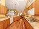 Bright kitchen features wood floors, light countertops, stainless steel appliances, and breakfast bar at 1653 Albino St, Nokomis, FL 34275