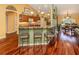 Kitchen featuring bar seating, wood cabinets, stainless appliances and an open layout at 1653 Albino St, Nokomis, FL 34275