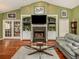 Well-lit living room with a fireplace, hardwood floors, and built-in shelving at 1653 Albino St, Nokomis, FL 34275