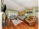 Cozy living area featuring a fireplace, hardwood floors, and comfortable seating at 1653 Albino St, Nokomis, FL 34275