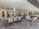 Expansive covered patio with dining, lounging, and hot tub areas for ultimate outdoor living at 1653 Albino St, Nokomis, FL 34275