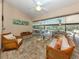 Inviting covered patio with comfortable seating areas and view of pool and screened-in enclosure at 1653 Albino St, Nokomis, FL 34275