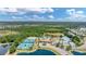 Overhead view capturing community amenities with a playground and pool with a serene lake in the background at 2094 Mesic Hammock Way, Venice, FL 34292