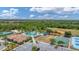 Expansive aerial showcasing community pool, playground, baseball field, and tennis courts, ideal for recreation at 2094 Mesic Hammock Way, Venice, FL 34292