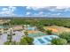 Aerial view showcasing community pool, clubhouse, tennis courts, park, and playground at 2094 Mesic Hammock Way, Venice, FL 34292