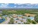 The overhead view highlights a pool, tennis courts, clubhouse, and playground, enhancing the community's appeal at 2094 Mesic Hammock Way, Venice, FL 34292
