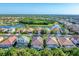 Aerial shot features serene lake views, manicured lawns, and pristine tiled roofs of community homes at 2094 Mesic Hammock Way, Venice, FL 34292
