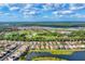 Aerial view of a residential community featuring waterfront homes and scenic surroundings at 2094 Mesic Hammock Way, Venice, FL 34292