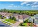 Aerial view of a well-maintained residential area featuring mature trees and lush green landscapes at 2094 Mesic Hammock Way, Venice, FL 34292