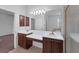 The bathroom boasts a double sink vanity with wood cabinetry, and a large mirror at 2094 Mesic Hammock Way, Venice, FL 34292