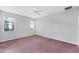 This empty bedroom is bathed in sunlight and features carpeted floors and a ceiling fan at 2094 Mesic Hammock Way, Venice, FL 34292
