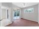 This bedroom has carpeted floors, a sliding glass door, and a large window at 2094 Mesic Hammock Way, Venice, FL 34292
